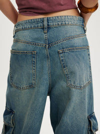 Vintage wash wide leg cargo jeans from Trendsi, showing relaxed fit, multiple pockets, and faded denim texture.