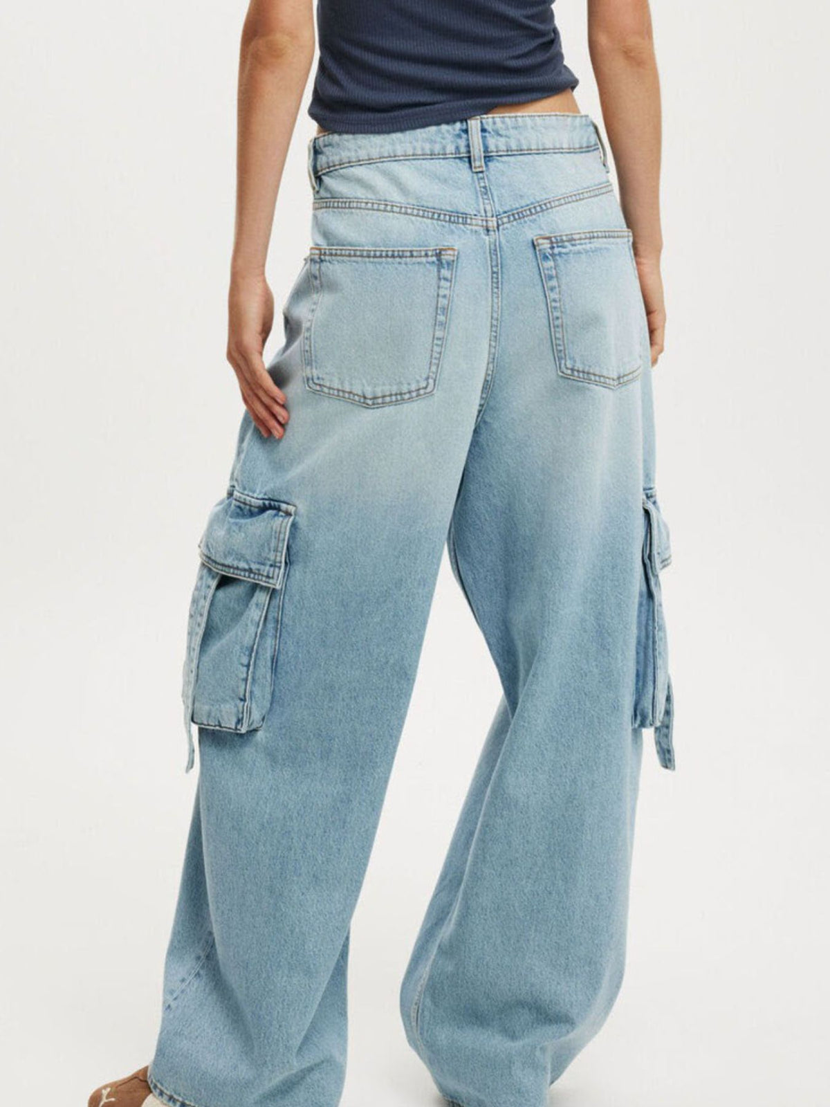 Vintage Wash Wide Leg Cargo Jeans from Trendsi featuring relaxed fit, multiple cargo pockets, and wide-leg style.