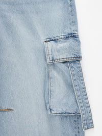 Vintage wash wide-leg cargo jeans from Trendsi featuring relaxed fit, large side pockets, and distressed denim detailing.