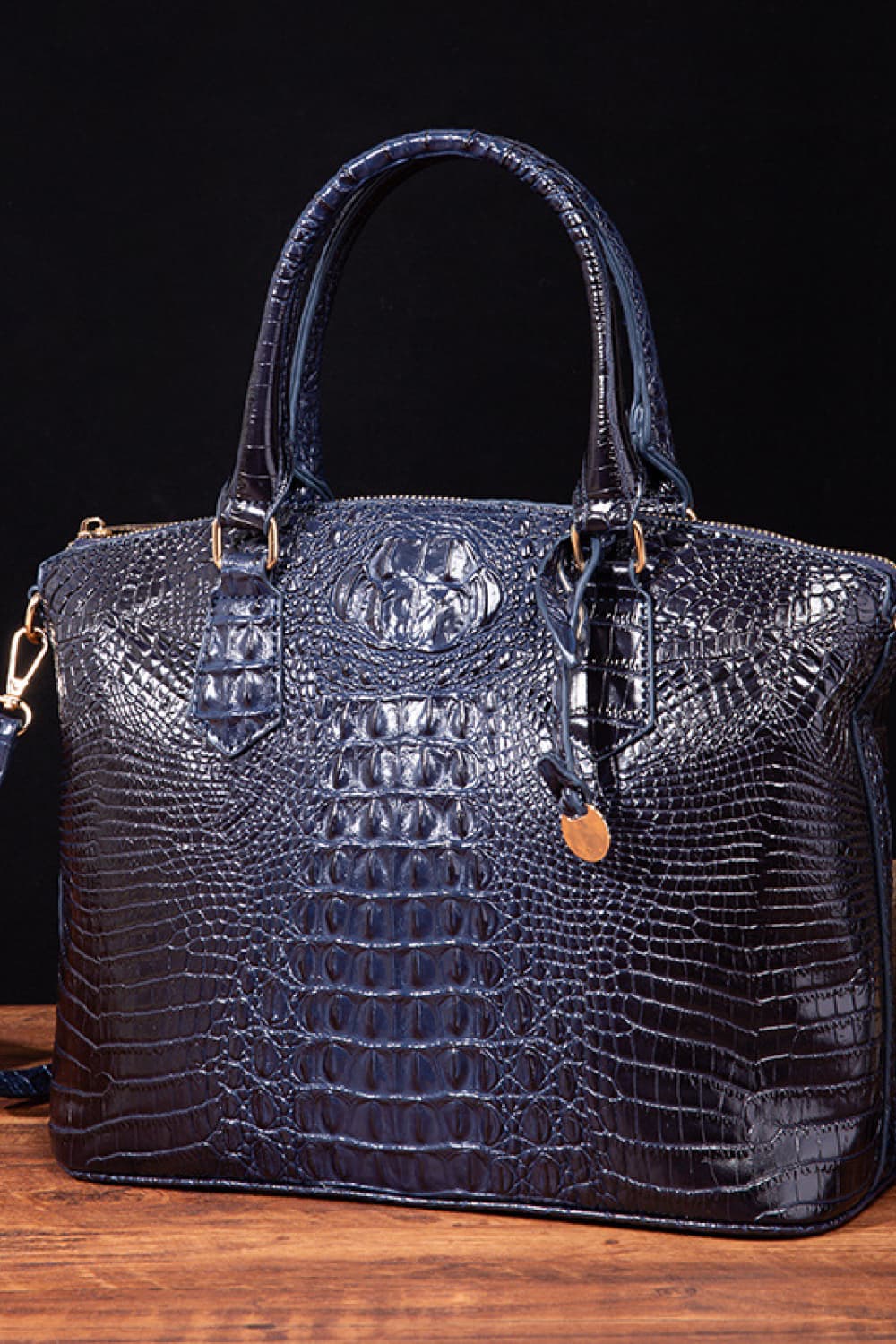 Black PU leather handbag with top handles and silver hardware, stylish and spacious for everyday use.