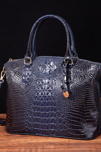 Black PU leather handbag with top handles and silver hardware, stylish and spacious for everyday use.