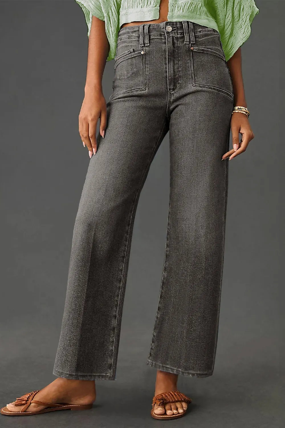 High-waisted wide-leg vintage wash jeans by Trendsi displayed on a model, showing relaxed fit and retro denim style.