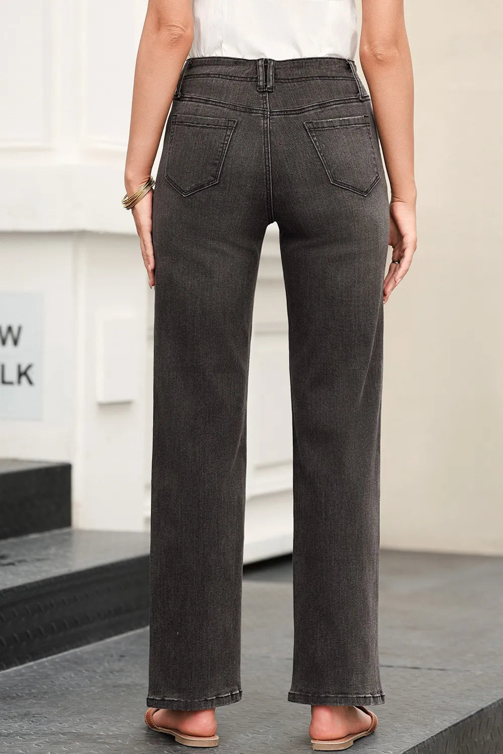 High-waisted wide-leg vintage wash jeans by Trendsi, showing front view with relaxed fit and faded denim texture.