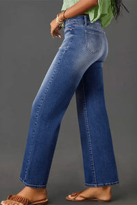 High-waisted wide-leg vintage wash jeans from Trendsi, featuring classic denim style and relaxed fit with faded wash detail.