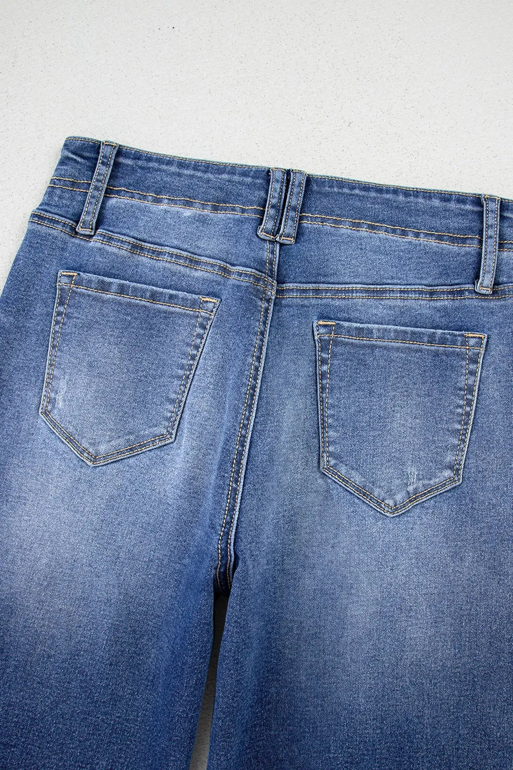 High-waisted wide-leg vintage wash jeans from Trendsi, showing the relaxed fit and distressed denim style.