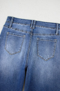 High-waisted wide-leg vintage wash jeans from Trendsi, showing the relaxed fit and distressed denim style.