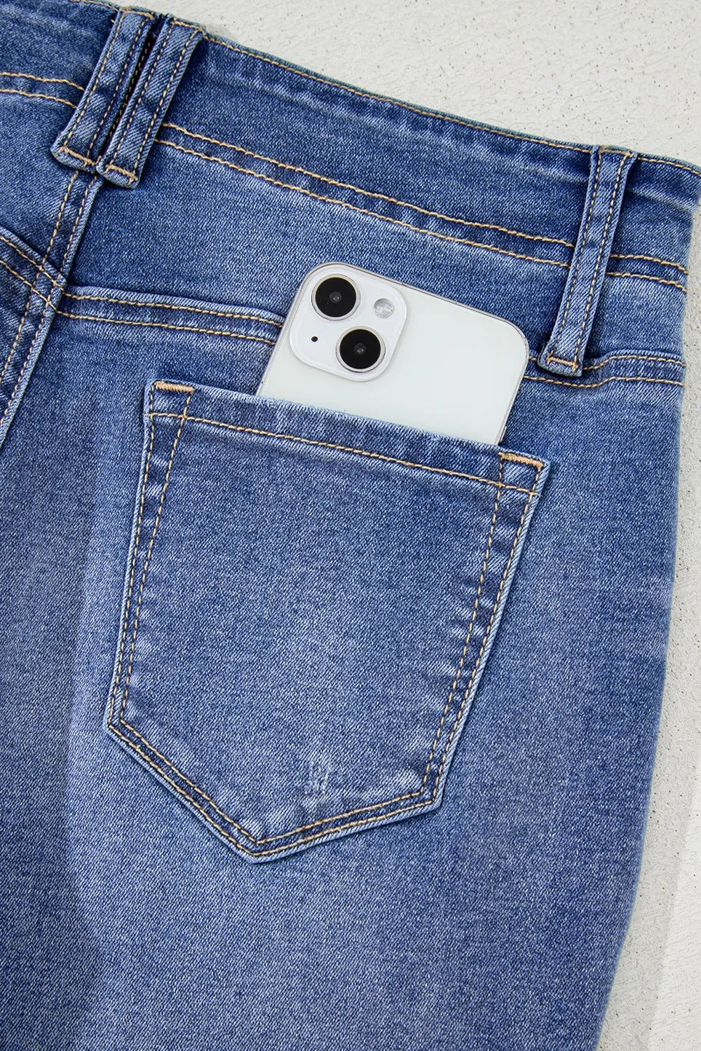 High-waisted vintage wash wide-leg jeans from Trendsi, with classic denim texture and relaxed fit visible in the image.