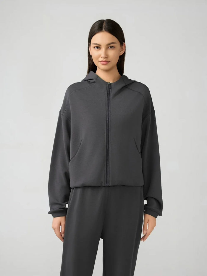 Trendsi Millennia zip-up hoodie with dropped shoulders and active fit, featuring a hood and full zipper in a stylish casual design.
