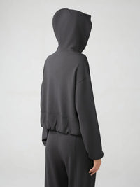 Trendsi Millennia zip-up hoodie with dropped shoulders, active fit, and hood, shown in black with front zipper and casual style.
