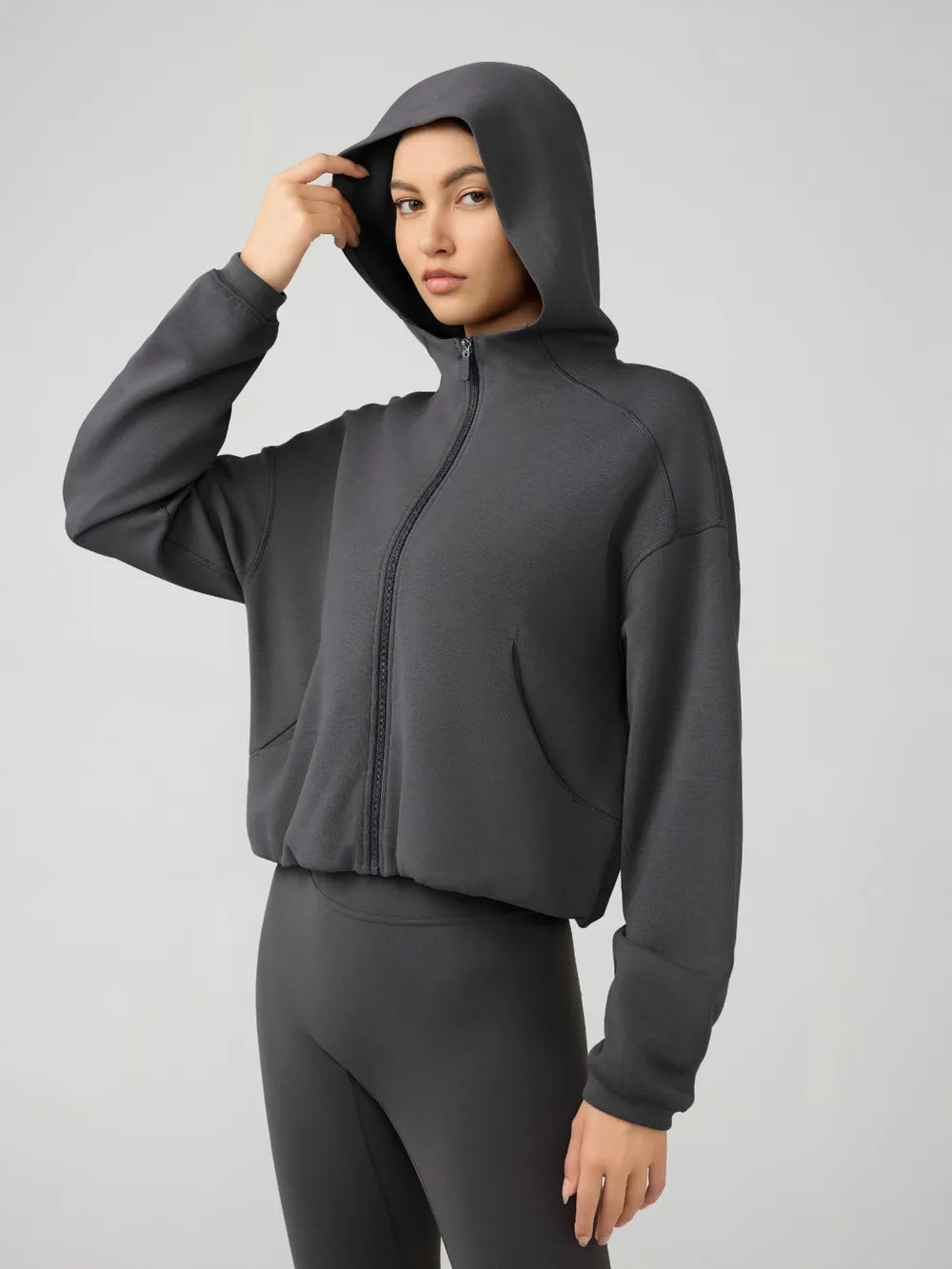 Trendsi Millennia zip-up hoodie with dropped shoulder design, active fit, hood, and full-length zipper, shown in the image.