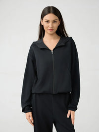 Millennia zip-up dropped shoulder active hooded sweatshirt by Trendsi, showing front view with hood and zip closure.