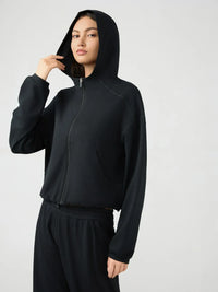 Trendsi Millennia zip-up active hoodie with dropped shoulders, hood, and sporty design, shown in black fabric.