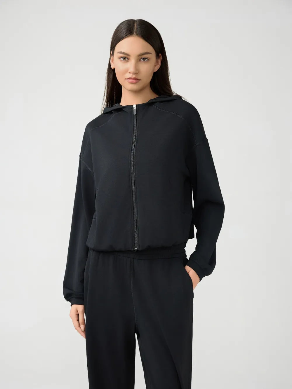 Millennia Zip Up Dropped Shoulder Active Hooded sweatshirt by Trendsi, featuring a zip front, dropped shoulders, and a casual fit.