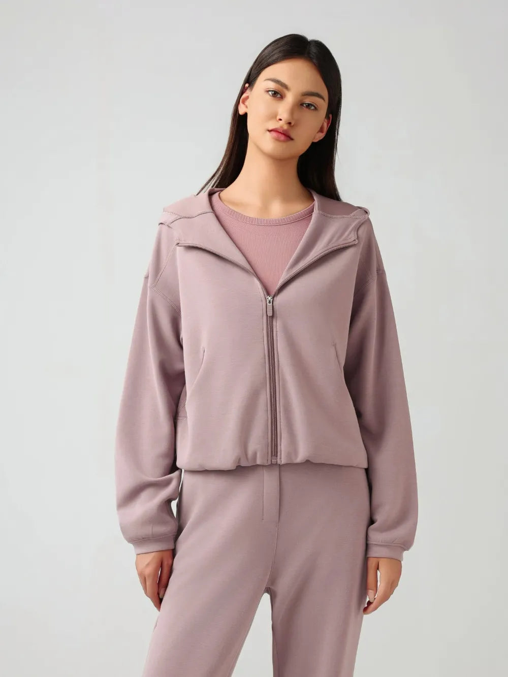 Trendsi Millennia zip-up active hoodie with dropped shoulders, hood, and front zipper, shown in a casual, relaxed fit.