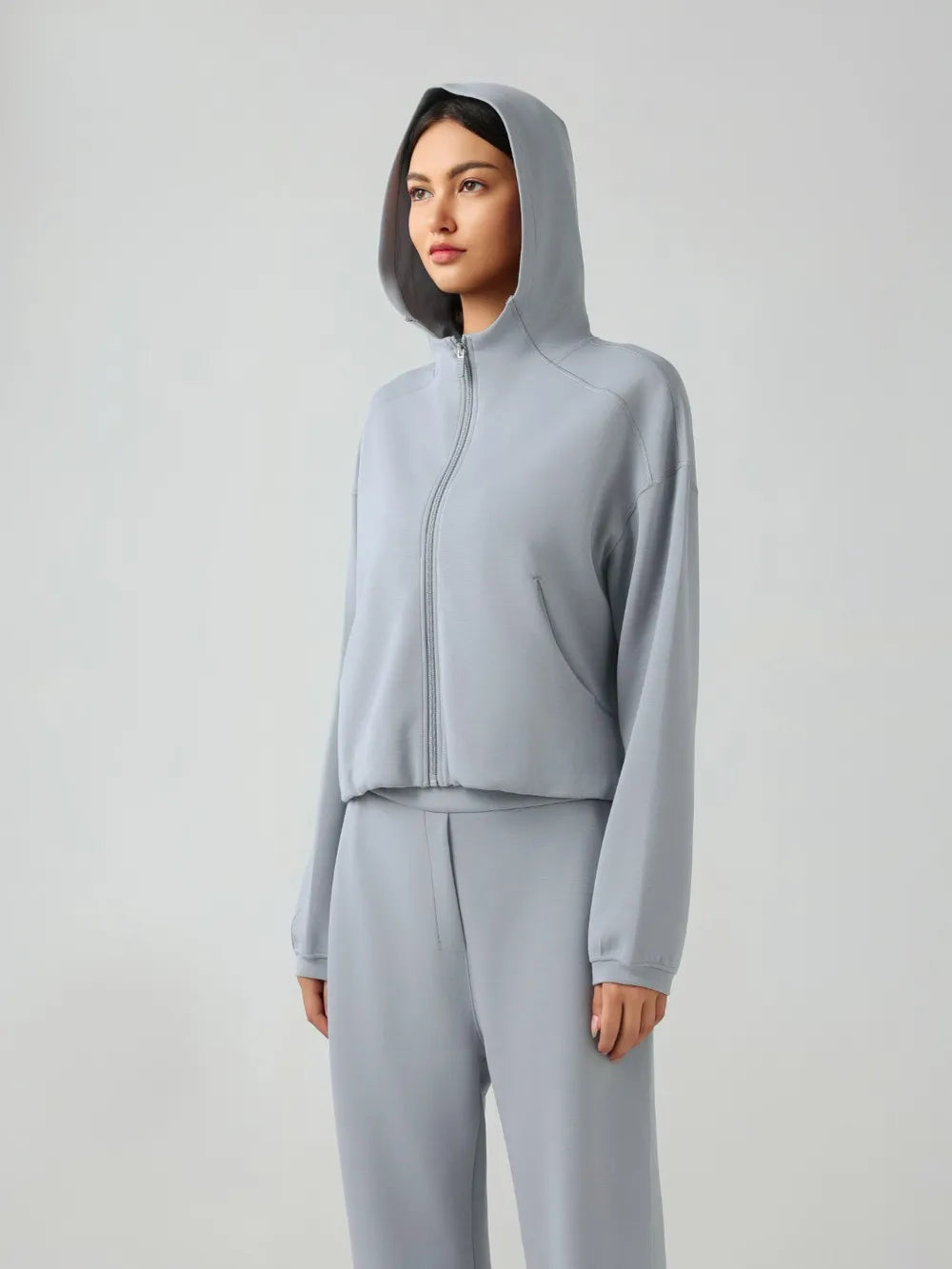Trendsi Millennia zip-up hoodie with dropped shoulders, active fit, hood, and front zipper, in a stylish casual design.