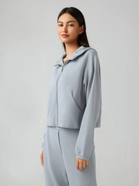 Trendsi Millennia zip-up active hoodie with dropped shoulders and hood, featuring a stylish, comfortable design.