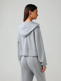 Trendsi Millennia zip-up active hoodie with dropped shoulders, hood, and front pockets, black color, casual athletic style.