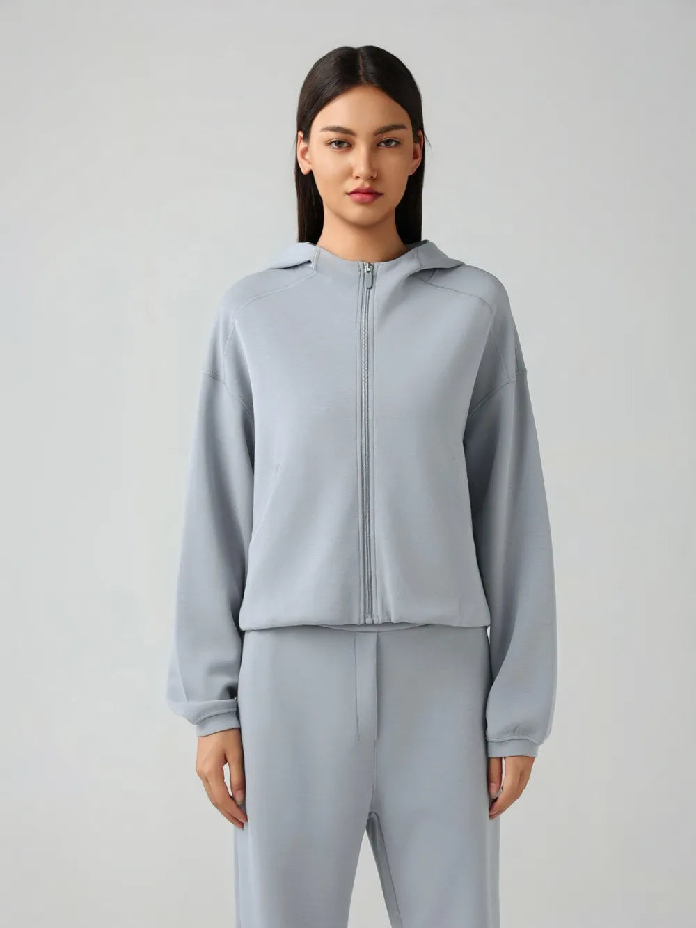 Trendsi Millennia zip-up hoodie with dropped shoulders, active fit, hood, and front zipper, shown in a casual style.