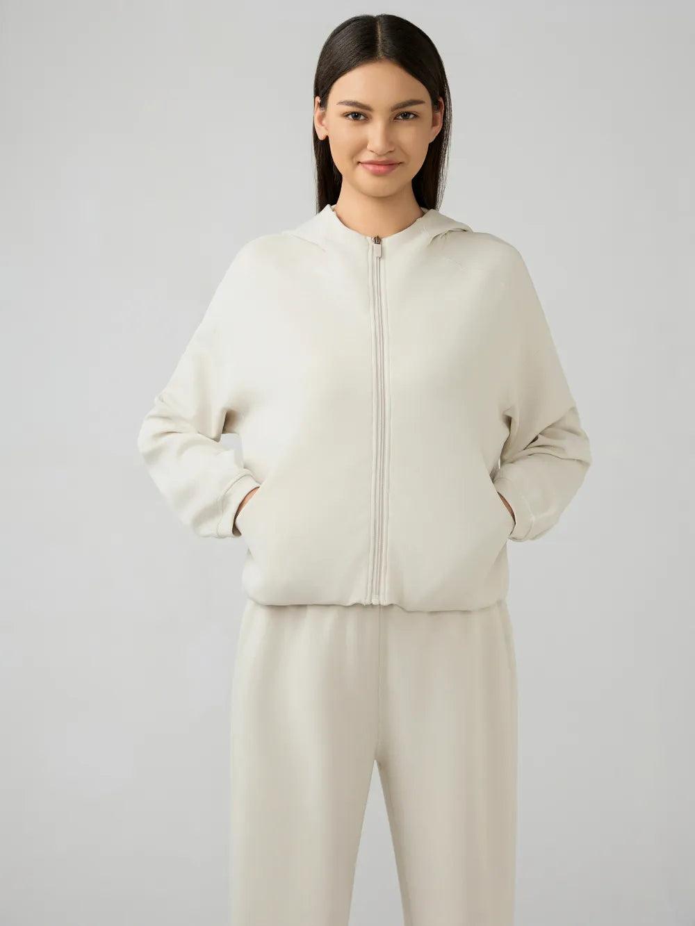 Trendsi Millennia zip-up hoodie with dropped shoulders and active hood, shown in a stylish front view.