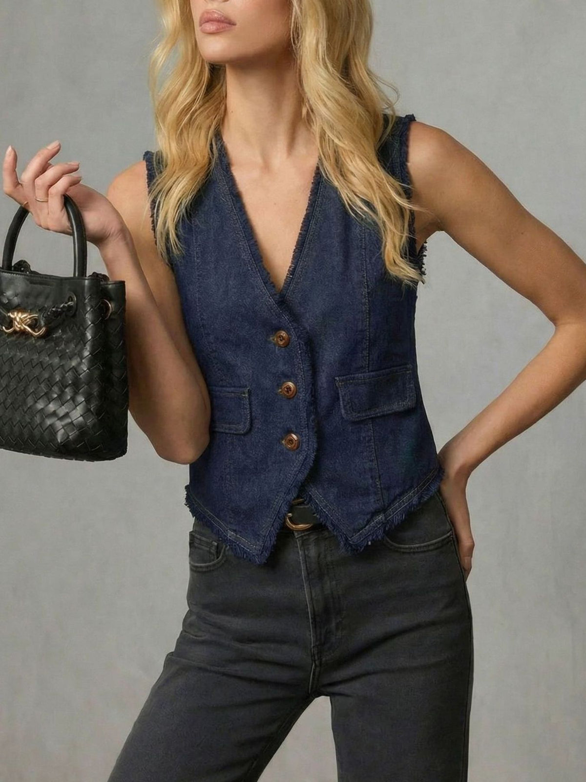 Frayed hem denim vest by Trendsi featuring distressed edges, classic sleeveless design, and light blue wash on a white background.