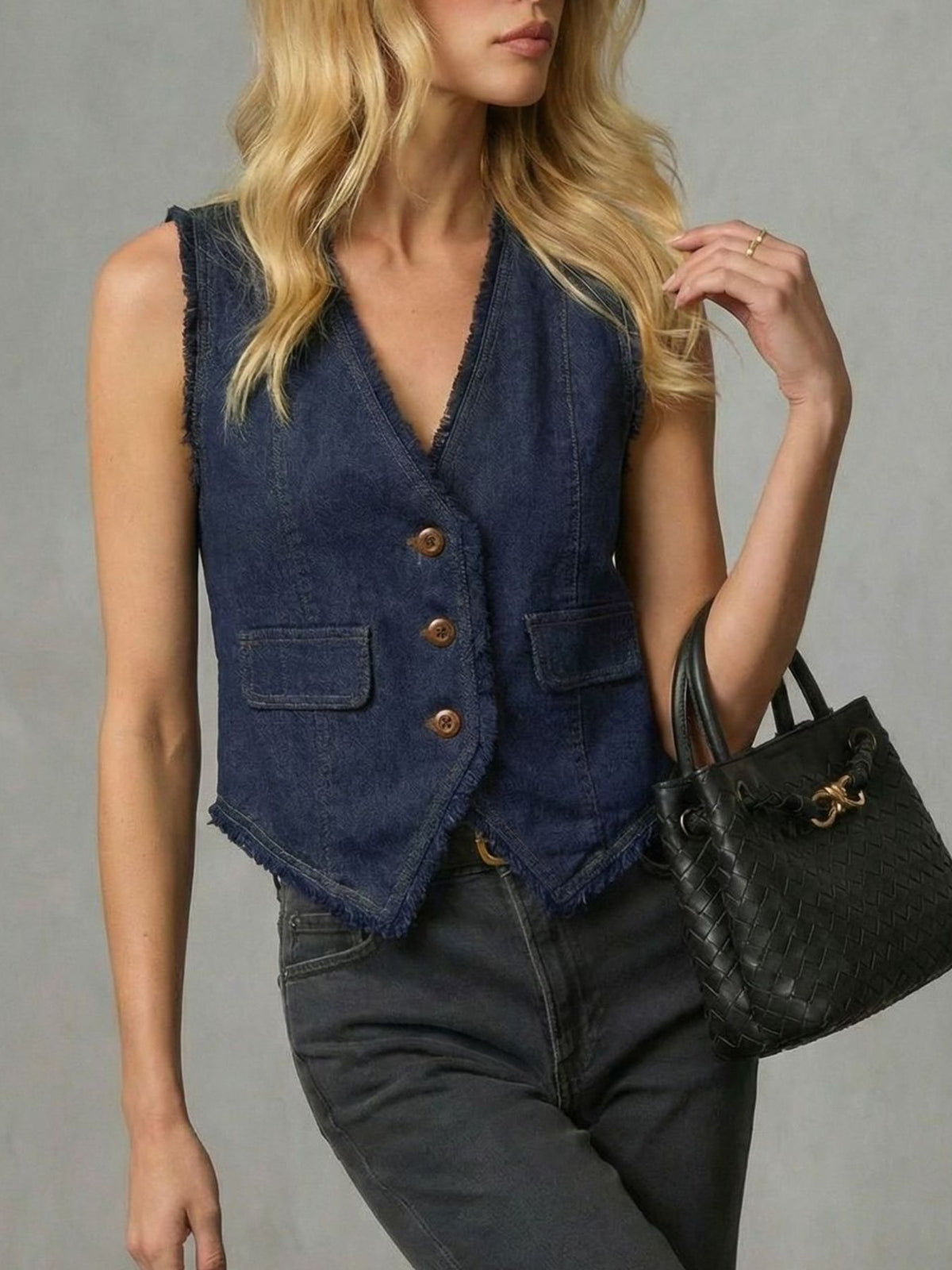Light blue frayed hem denim vest from Trendsi, featuring distressed edges and sleeveless design on a plain background.
