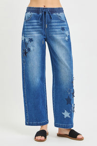 Dark RISEN elastic band slouchy cropped barrel pants with star patch by Trendsi, featuring a relaxed fit and stylish design.