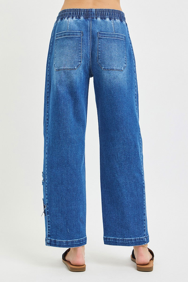 Dark-colored RISEN elastic band slouchy cropped barrel pants with star patch, stylish and comfortable for casual wear.
