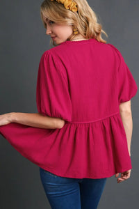 Plus size Umgee cotton gauze babydoll blouse with floral embroidery, featuring a flowy design and short sleeves.