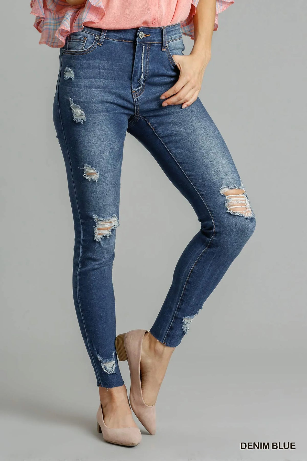 Blue Umgee distressed skinny jeans with pockets, featuring a fitted silhouette and casual denim style.