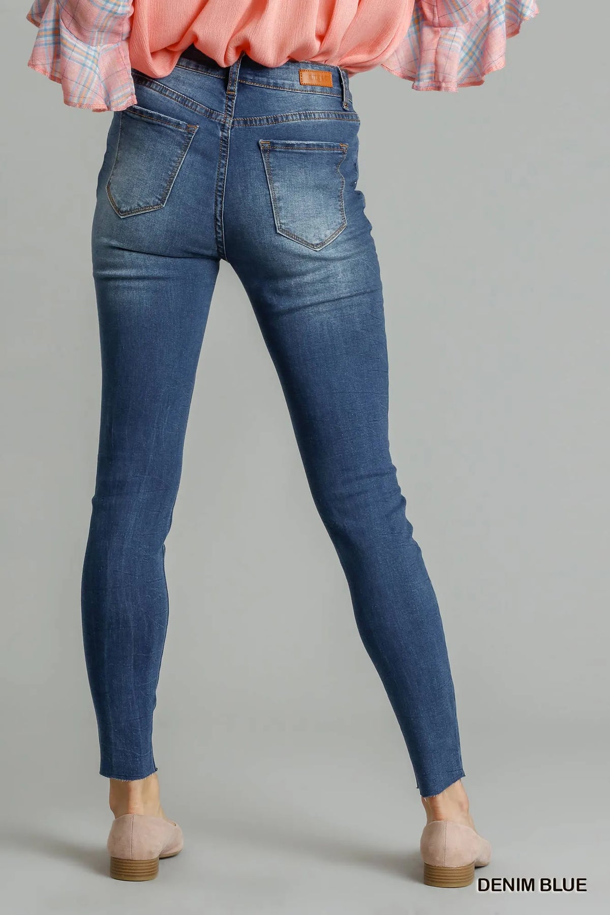 Blue distressed skinny jeans by Umgee with front pockets, fitted style, casual denim look, shown on a model.