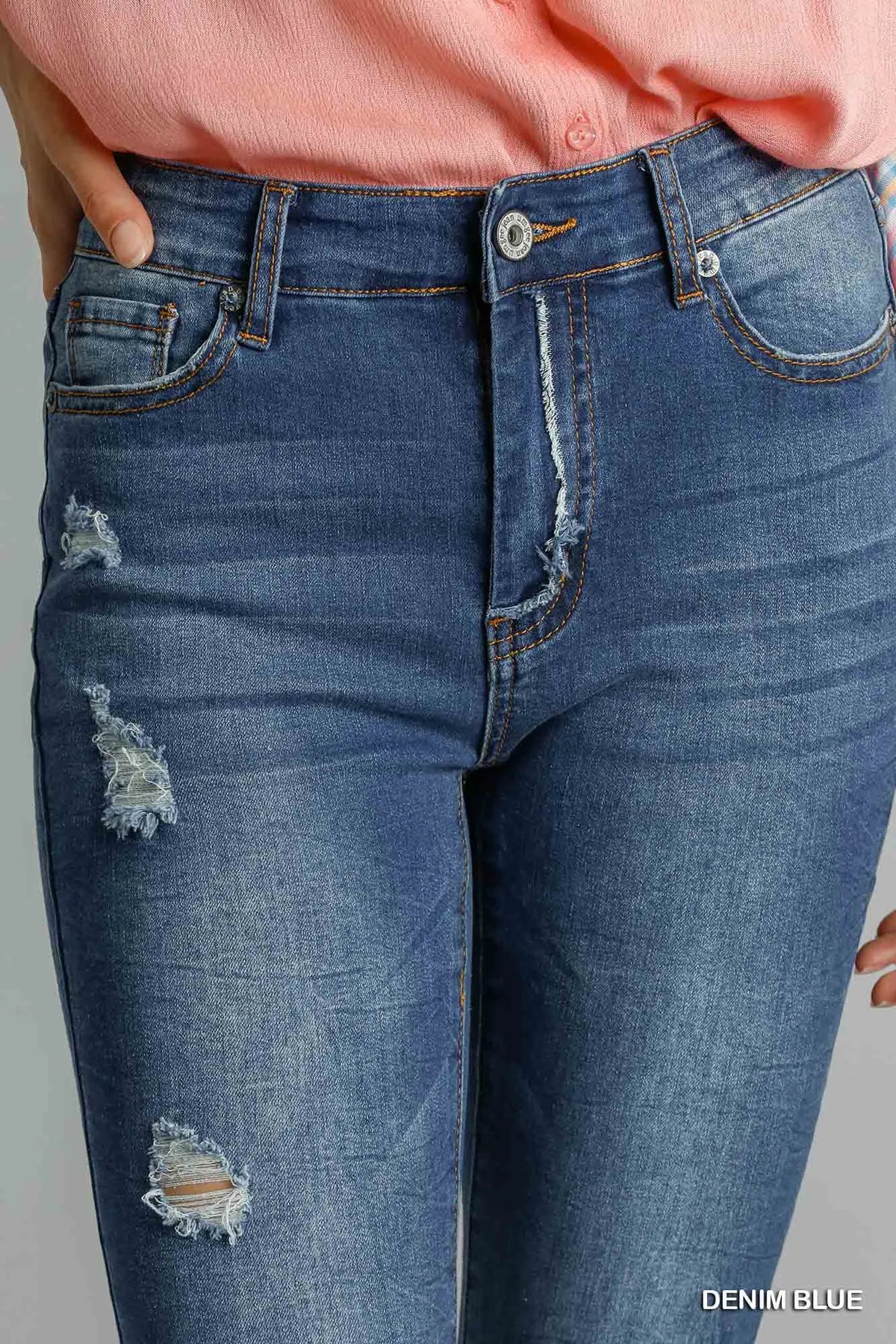 Blue distressed skinny jeans by Umgee with pockets, featuring a fitted design and casual denim style.