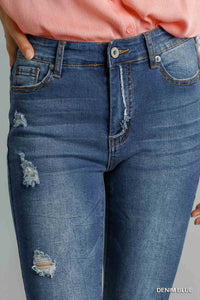 Blue distressed skinny jeans by Umgee with pockets, featuring a fitted design and casual denim style.