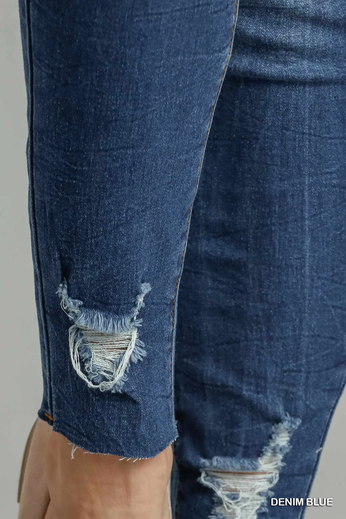 Blue Umgee distressed skinny jeans with pockets, featuring a fitted style and casual denim look.