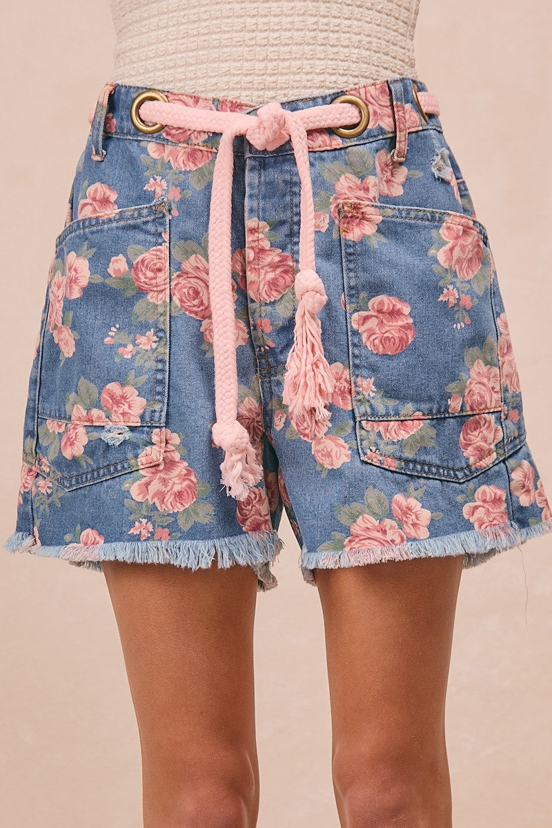 Trendsi BiBi braided waist belt with patch pockets styled on floral print denim shorts, showcasing a casual summer look.