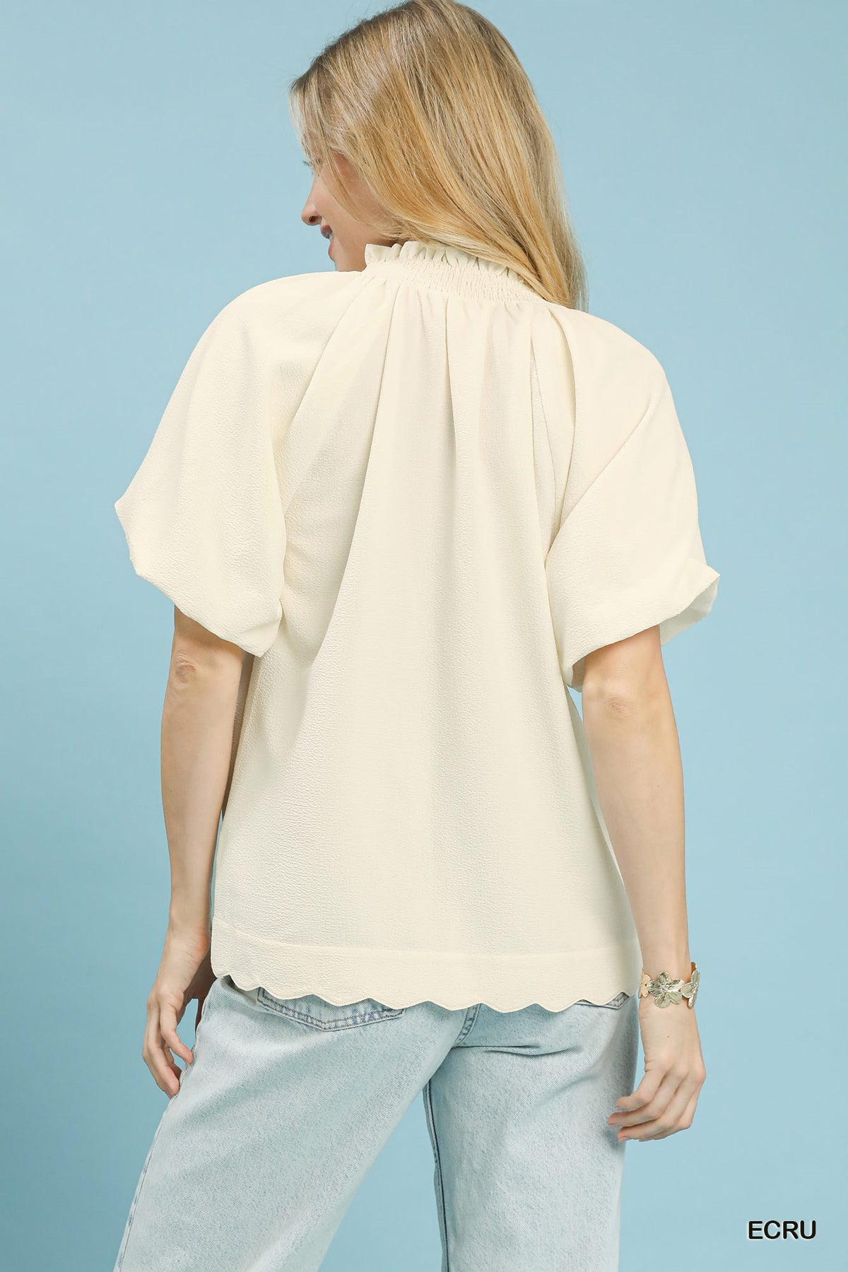 Textured Umgee scalloped hem blouse with long sleeves and relaxed fit, shown on a hanger against a neutral background.
