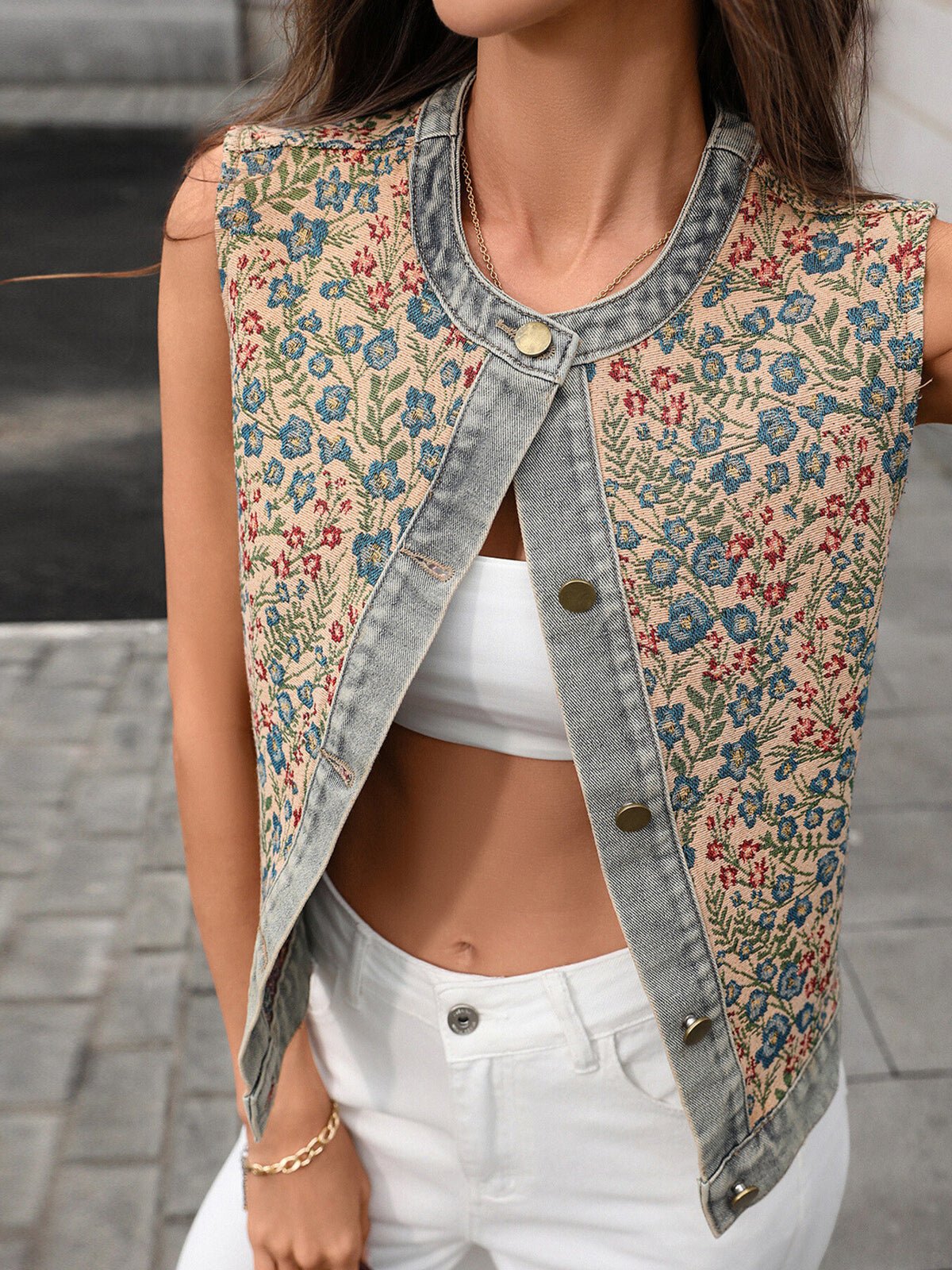 Floral embroidered sleeveless denim top from Trendsi, showcasing intricate floral embroidery on classic blue denim fabric.