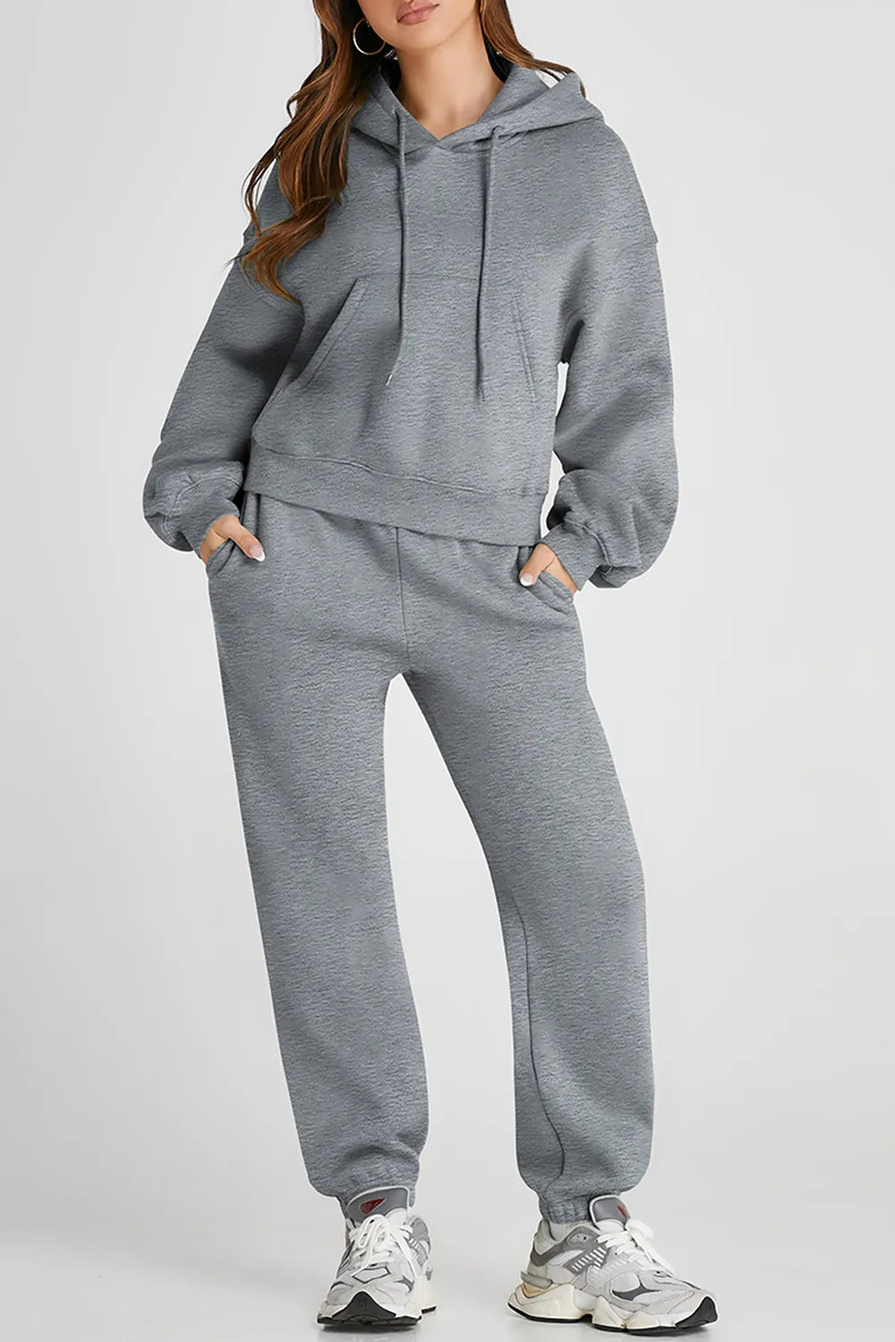 Dropped shoulder hooded top and matching active pants set by Trendsi, featuring a relaxed fit and comfortable athletic style.