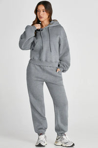 Dropped shoulder hooded top and matching pants active set by Trendsi, featuring a relaxed fit and casual style.