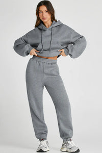 Dropped shoulder hooded top and pants active set by Trendsi, featuring a relaxed fit with hood and matching jogger pants.