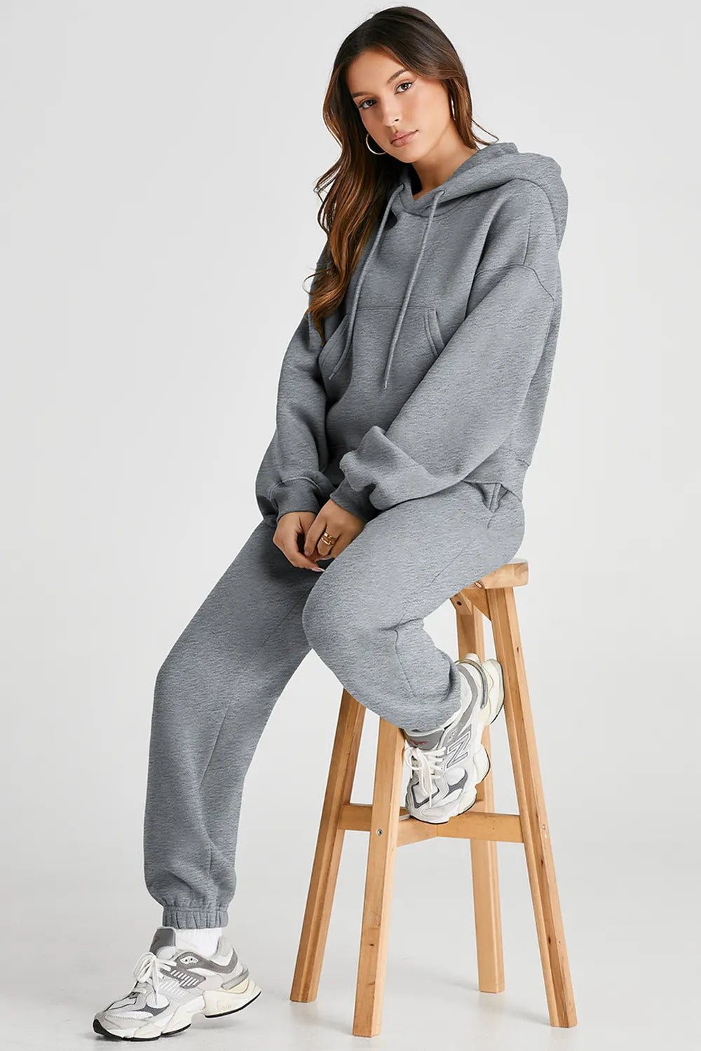 Dropped shoulder hooded top and pants active set from Trendsi, featuring a relaxed fit and casual sporty style.