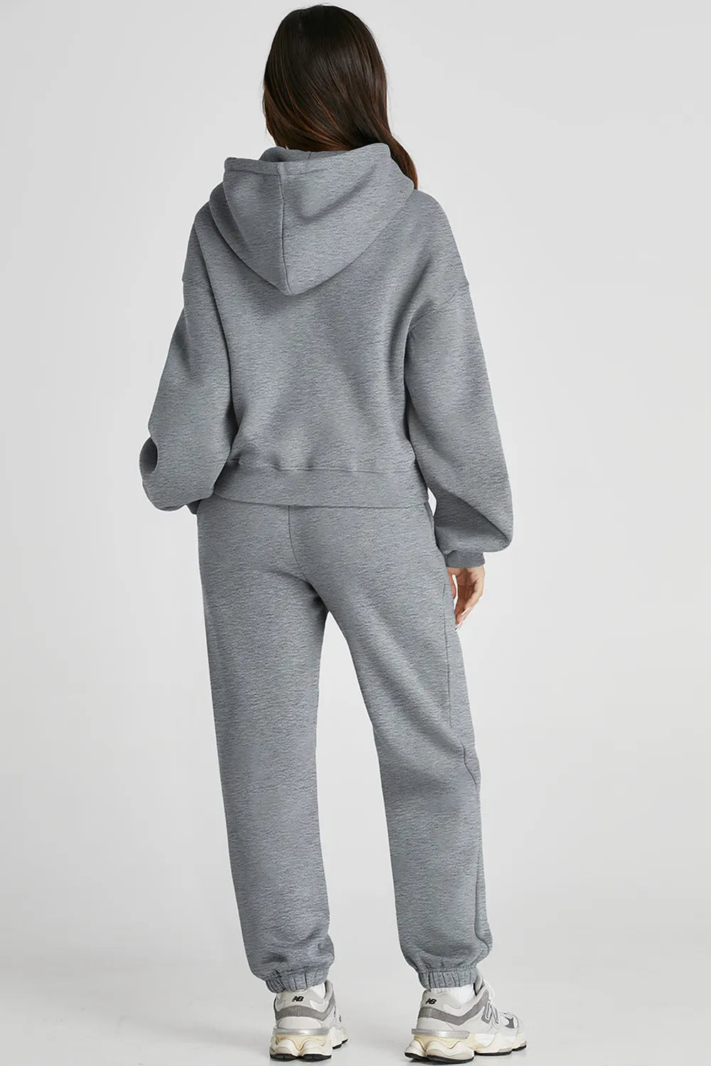 Dropped shoulder hooded top and matching pants active set by Trendsi, featuring a relaxed fit and casual style.