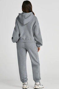 Dropped shoulder hooded top and matching pants active set by Trendsi, featuring a relaxed fit and casual style.
