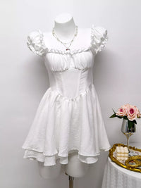 Gray and white ruffle-trimmed layered mini dress by Trendsi, featuring a feminine, flowy design with ruffle accents.