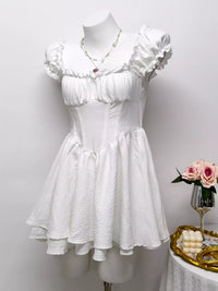 Gray and white ruffle-trimmed layered mini dress by Trendsi, featuring a stylish and feminine design with ruffle details.