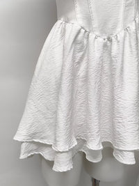 Gray and white ruffle-trimmed layered mini dress by Trendsi, featuring a stylish and playful design with ruffle accents.