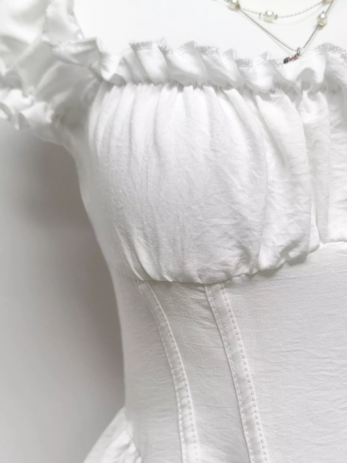 Gray and white ruffle-trimmed layered mini dress from Trendsi, showcasing a stylish and feminine design with ruffle details.