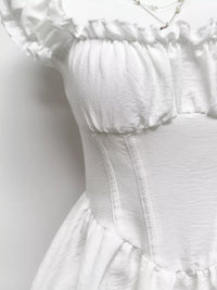 Gray and white ruffle-trimmed layered mini dress from Trendsi, featuring a flouncy design and feminine details.