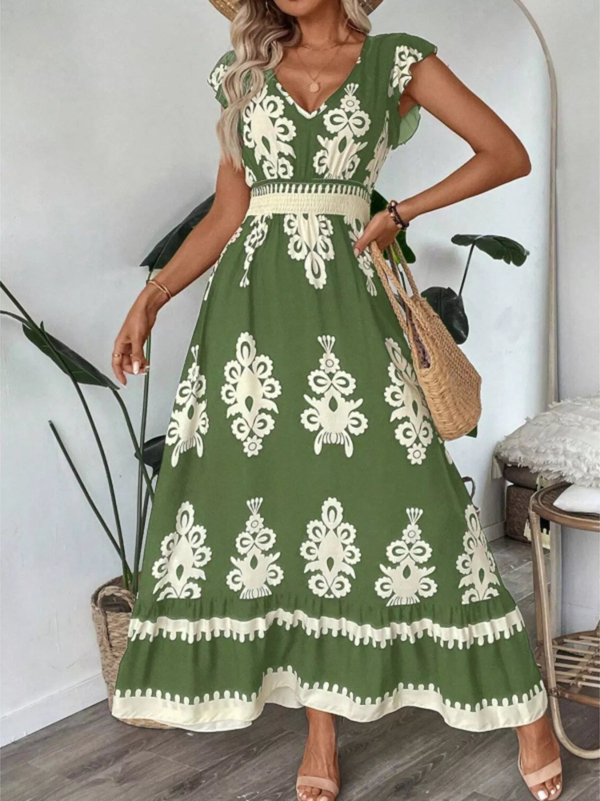 Green printed V-neck dress with ruffled cap sleeves by Trendsi, featuring a stylish and feminine design.