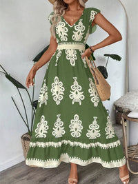 Green printed V-neck dress with ruffled cap sleeves by Trendsi, featuring a stylish and feminine design.