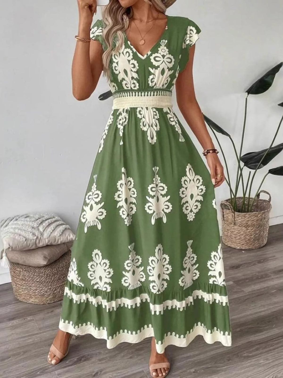 Green printed V-neck dress with ruffled cap sleeves by Trendsi, featuring a stylish and feminine design.